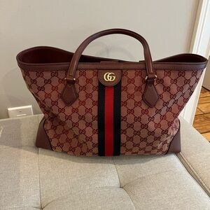 Gucci GG denim tote.
The color is actually Burgundy not red.